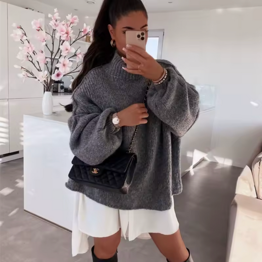 A cozy, oversized knit with a sleek half-turtleneck and timeless solid colors, perfect for effortless elegance and everyday warmth.